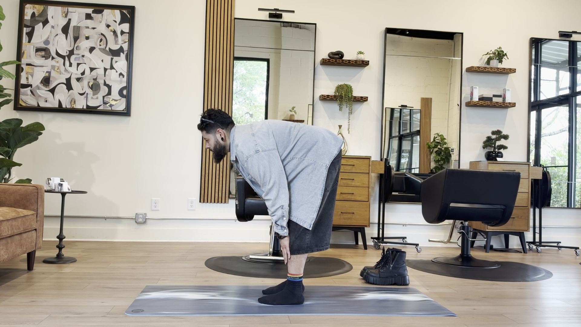 Yoga teacher Jairo Menendez practicing Halfway Lift after standing all day