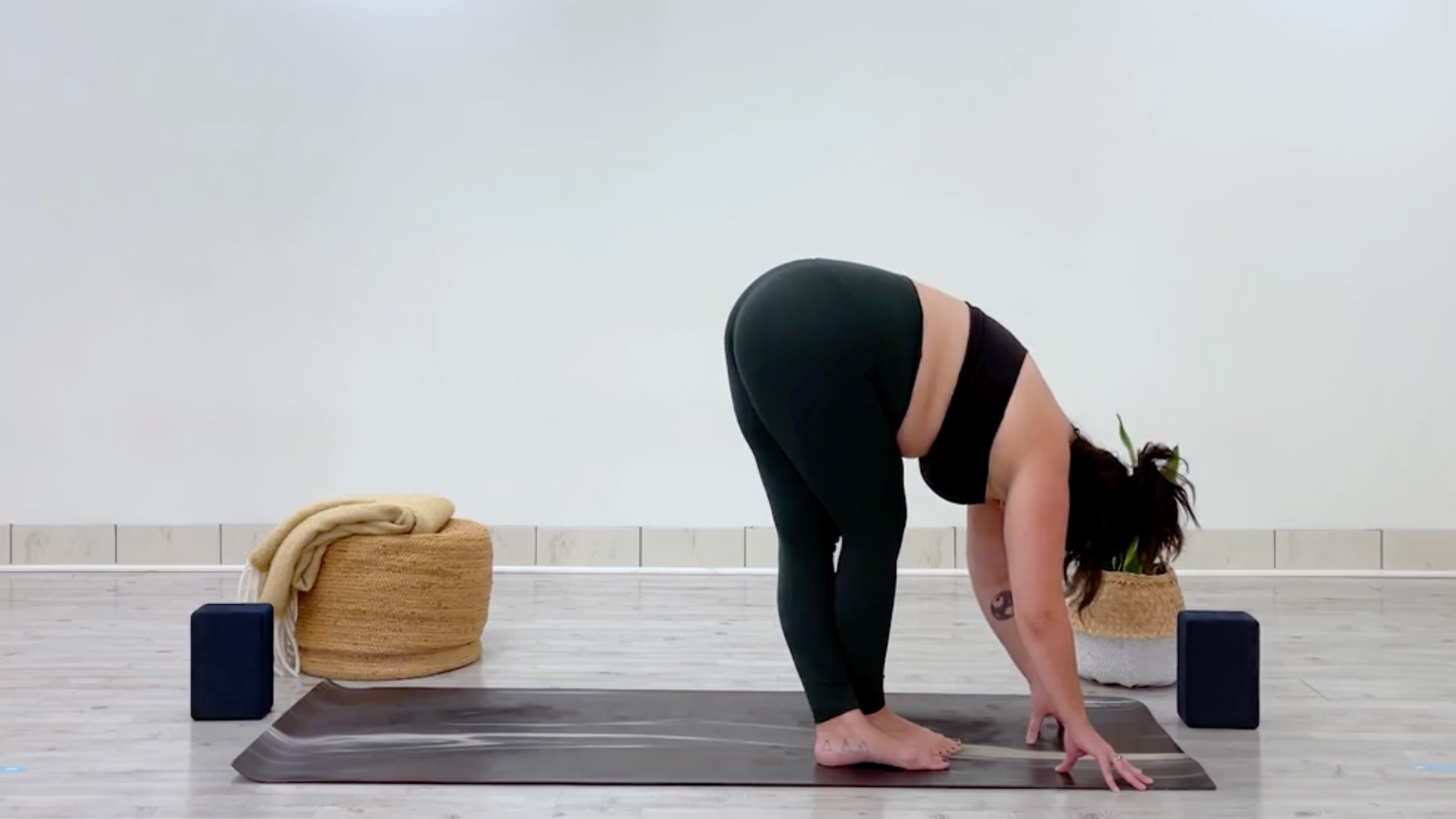 Teacher Taylor Lorenz in Cross-Legged Standing Forward Bend