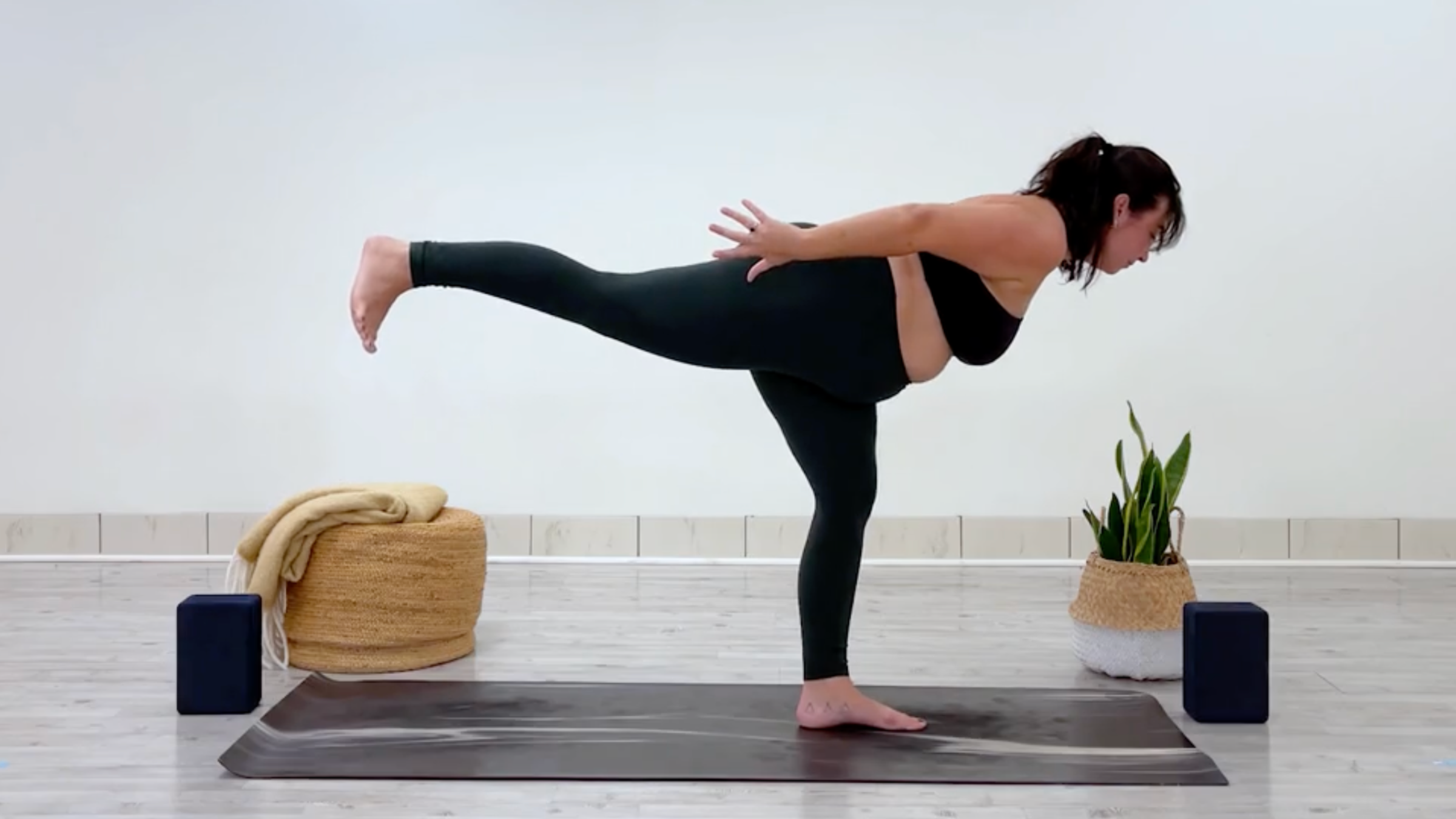 Yoga teacher Taylor Lorenz in Warrior 3, part of her yoga for balance practice